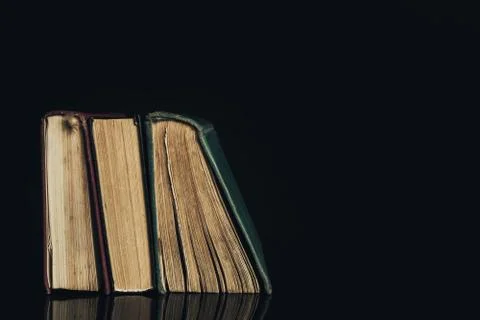 Beautiful ancient books. Pattern background for design. The book on a black g Stock Photos