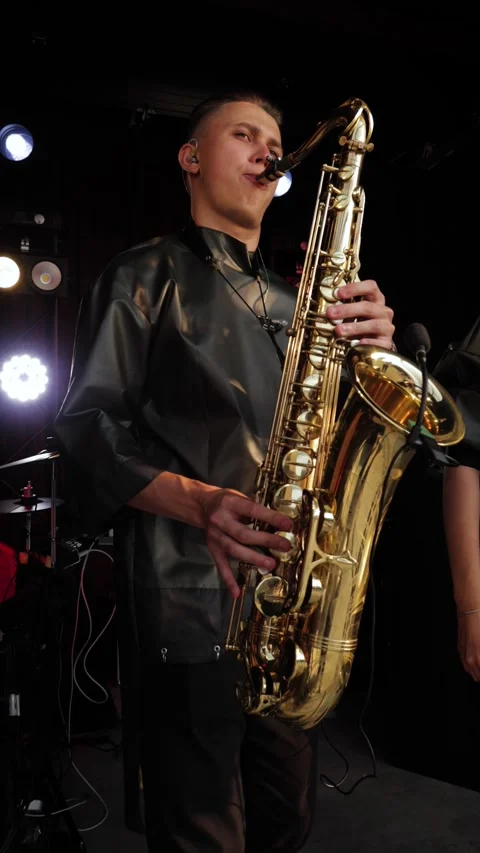 A beautiful and attractive singer performs with her band at a concert or a Stock Footage 279917528