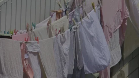 A beautiful and colorful array of laundry hanging peacefully on a clothesline Stock Footage 309802102