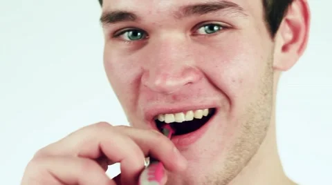 Beautiful and cute man cleans teeth with a toothbrush. Close-up. Stock-Footage 59348127