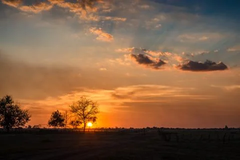 Beautiful and dramatic sunset on the plain Stock Photos
