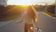 Beautiful And Fashion Young Woman Posing At The Sunset With A Skateboard Stock Footage