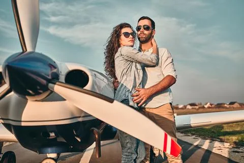 Beautiful and happy young couple posing in front of an old retro private prop Stock Photos