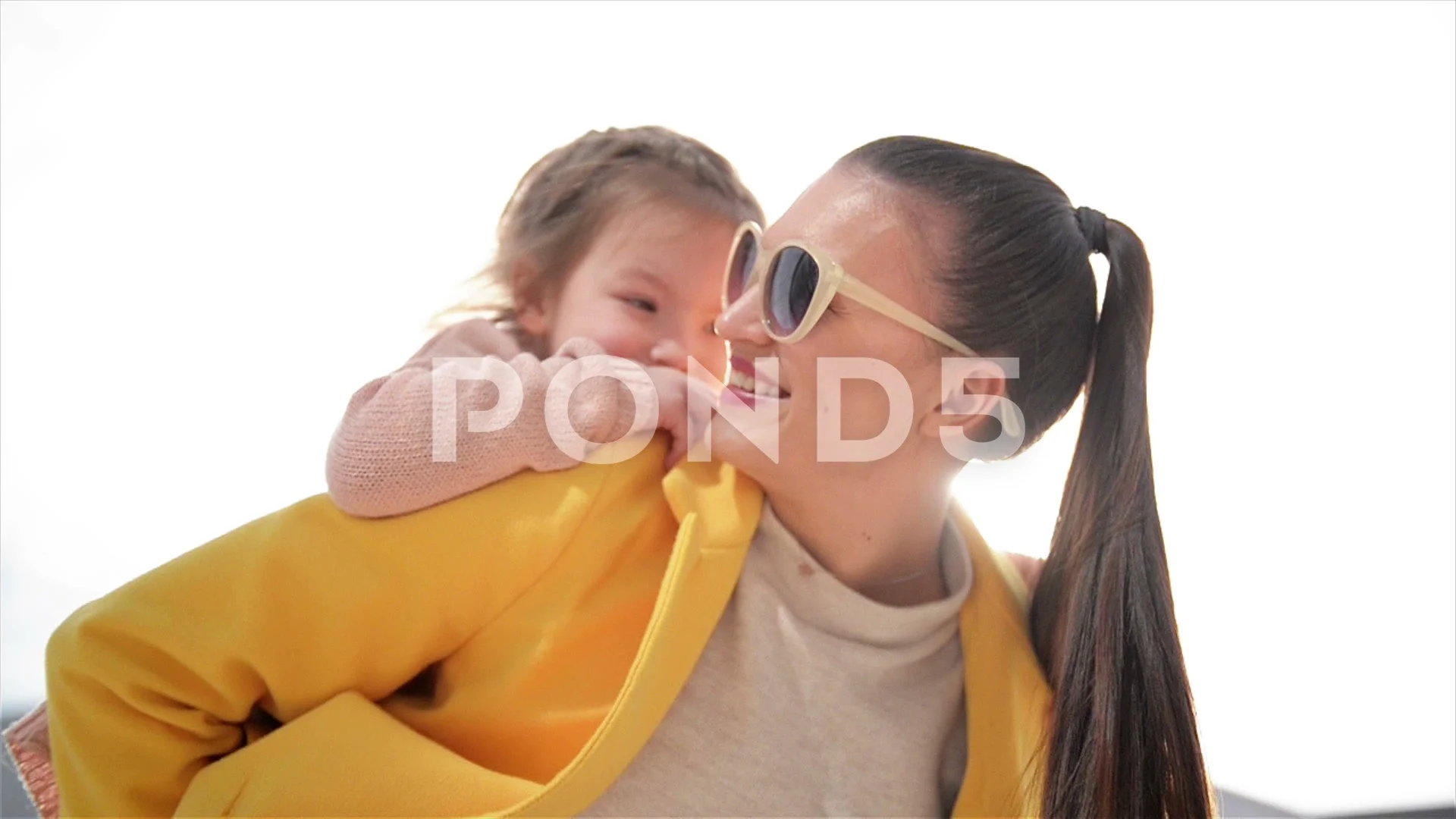 Happy mother giving her son a piggyback ride in the city stock photo