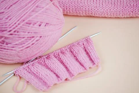 A Beautiful and Harmonious Composition Featuring Soft Pink Knitting Yarn an.. Stock Photos