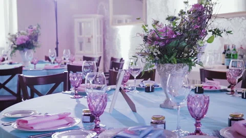 Beautiful and stylish table setting dishes and flowers for celebrations Stock Footage 98333584