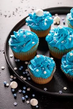 Beautiful and unique cupcakes with blue whipped cream. Stock Photos