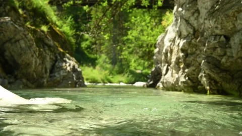 Beautiful and wild small stream in the mountains with water flowing in a pond Stock Footage 211489409