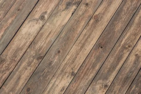 A beautiful angle texture of old yellow and brown boards with knots in the ph Stock Photos