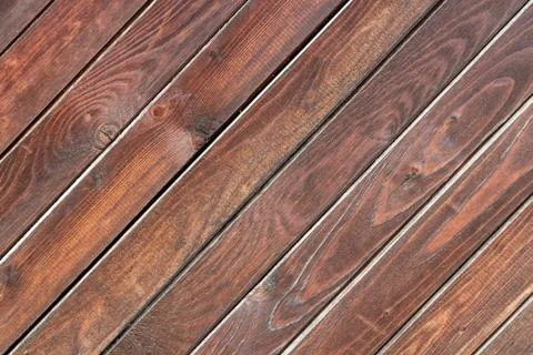 A beautiful angle texture of old yellow and brown boards with knots in the ph 스톡 사진