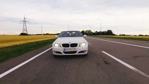 A beautiful appearance of bmw e90 at sunset near fields Video stock 91662521