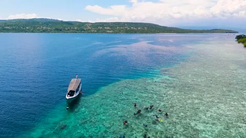 Beautiful arial drone view blue beach sea ocean ship boat people snorkling Видео 260471003