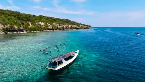 Beautiful arial drone view blue beach sea ocean ship boat people snorkling Stock Footage 260476386
