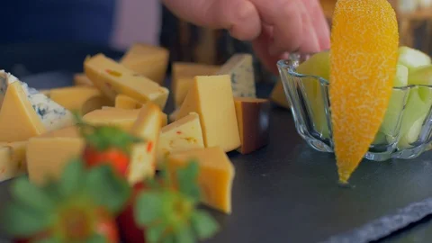 Beautiful arrangement of different types of cheeses on a black stone Video stock 109126849