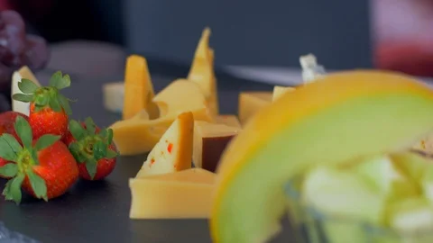 Beautiful arrangement of different types of cheeses on a black stone Stockbeeldmateriaal 109129304