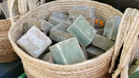 A beautiful arrangement of handmade soap placed inside a basket at the local Stock Footage 346738894