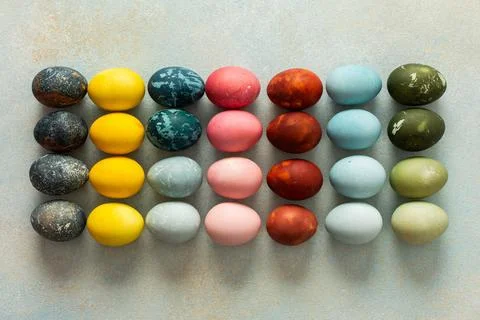 A beautiful array of hand-dyed Easter eggs in various colors, neatly arranged Stock Photos