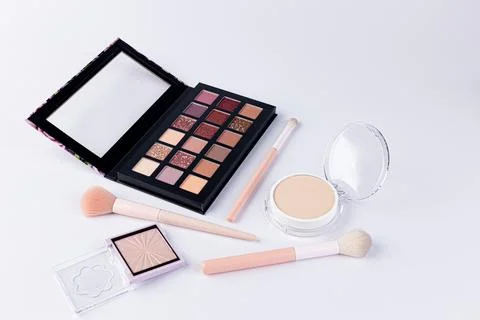 A Beautiful Array of Makeup Essentials Featuring an Eye Shadow Palette Stock Photos