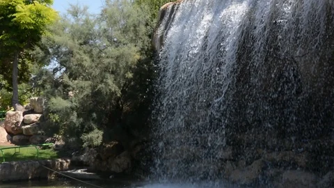 A beautiful artificial waterfall in entertaining park Vídeos de archivo 93682547