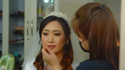 Beautiful Asian Bride Looking at Mirror While Make-Up on Her Wedding Day Stock Footage 333353007
