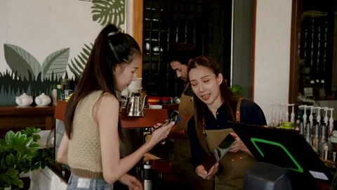 Beautiful Asian customer using smartphone to scan barcode to pay through Stock Footage 247041093