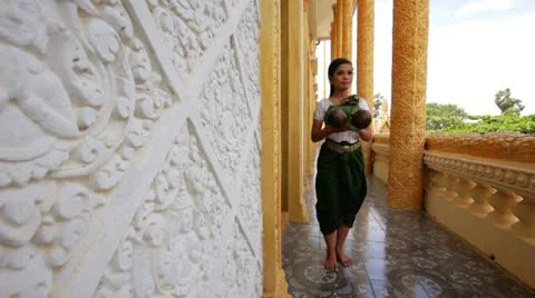 Beautiful Asian Girl performs coconut folk dance in temple Stock Footage