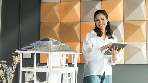 Beautiful asian project manager using tablet check house model. Manipulator. 写真素材