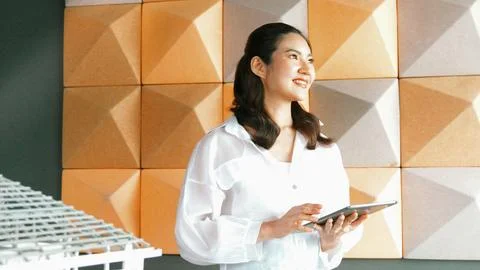 Beautiful asian project manager using tablet check house model. Manipulator. Stock Photos