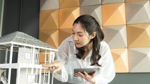 Beautiful asian project manager using tablet check house model. Manipulator. 스톡 사진