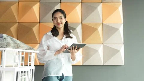 Beautiful asian project manager using tablet check house model. Manipulator. 写真素材