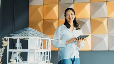 Beautiful asian project manager using tablet check house model. Manipulator. 写真素材