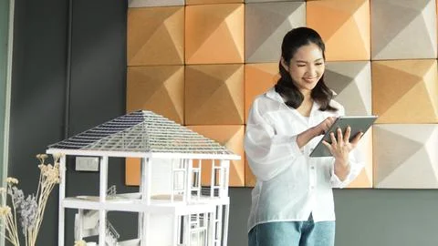 Beautiful asian project manager using tablet check house model. Manipulator. 写真素材