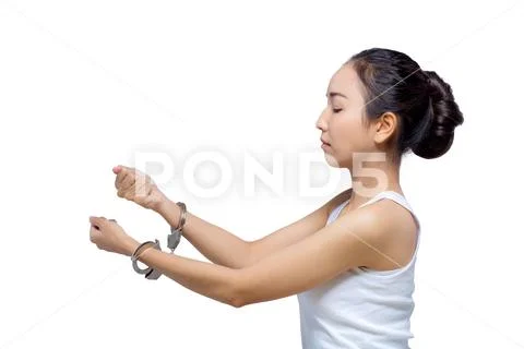 Beautiful Asian woman with pure face and her hand in shackle,She can not make Stock Photos