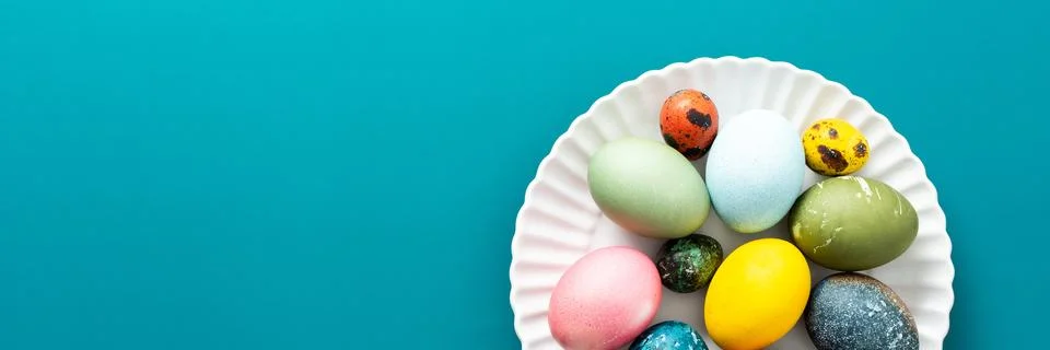 A beautiful assortment of Easter eggs in various colors and patterns is displ Stock Photos