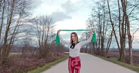 A beautiful athletic woman using stretch tape Stock Footage 146109043