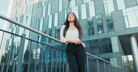 Beautiful attractive elegantly dressed in white shirt woman stands at railing Stock Footage 164230752