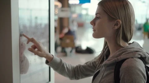 Beautiful attractive woman in airport terminal. Ordering food via self-service Stock Footage