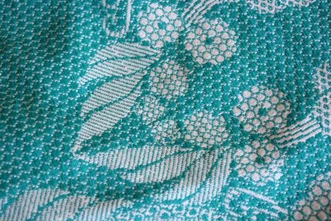 Beautiful authentic Ukrainian pattern on fabric of flowers, leaves, petals. Stock Photos