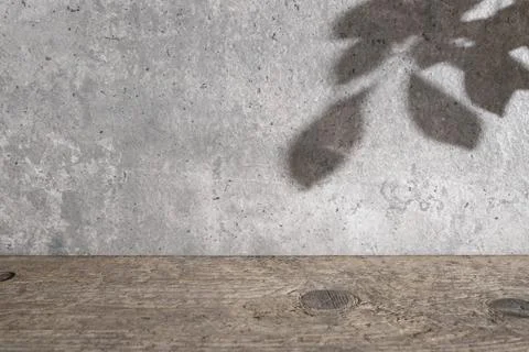 Beautiful backdrop with cement textured wall, weathered wood desk and tree .. Stock Photos