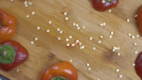 Beautiful background of chopped bell pepper and seeds on a cutting board Vidéo 116504833