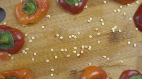 Beautiful background of chopped bell pepper and seeds on a cutting board Stock Footage 116504893