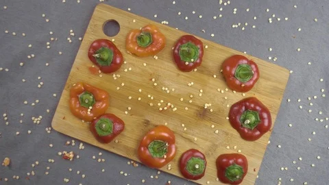 Beautiful background of chopped bell pepper and seeds on a cutting board Stock Footage 116505009