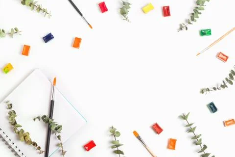 Beautiful background with dry eucalyptus, pan watercolors, ribbons and brushe Stock Photos