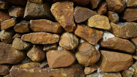 Beautiful background pattern image of a wall made of round stone red color ro Stock Photos