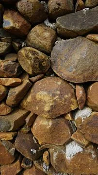 Beautiful background pattern image of a wall made of round stone red color ro Stock Photos