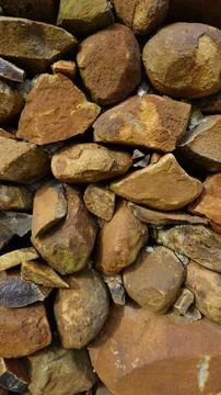 Beautiful background pattern image of a wall made of round stone red color ro Stock Photos