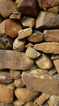 Beautiful background pattern image of a wall made of round stone red color ro Stock Photos