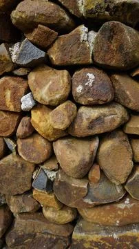 Beautiful background pattern image of a wall made of round stone red color ro Stock Photos