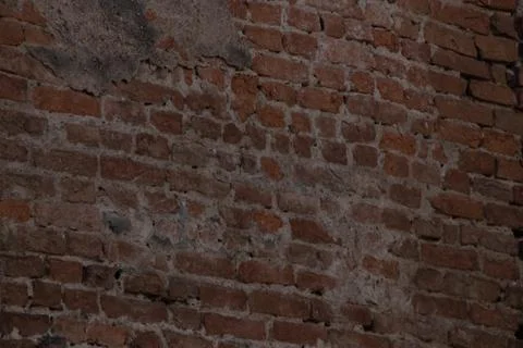 A beautiful background of red bricks, the plaster fell due to the years Stock Photos