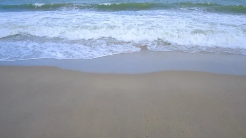 Beautiful background transparent surface wave, sand on clean seaside beach Stock Footage 101419607